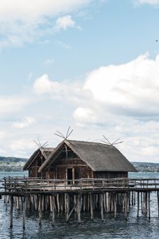 Charming wooden huts on stilts over water, evoking a peaceful lakeside retreat.