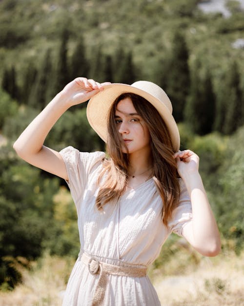 Fashion Girl Posing in White Summer Dress and Hat