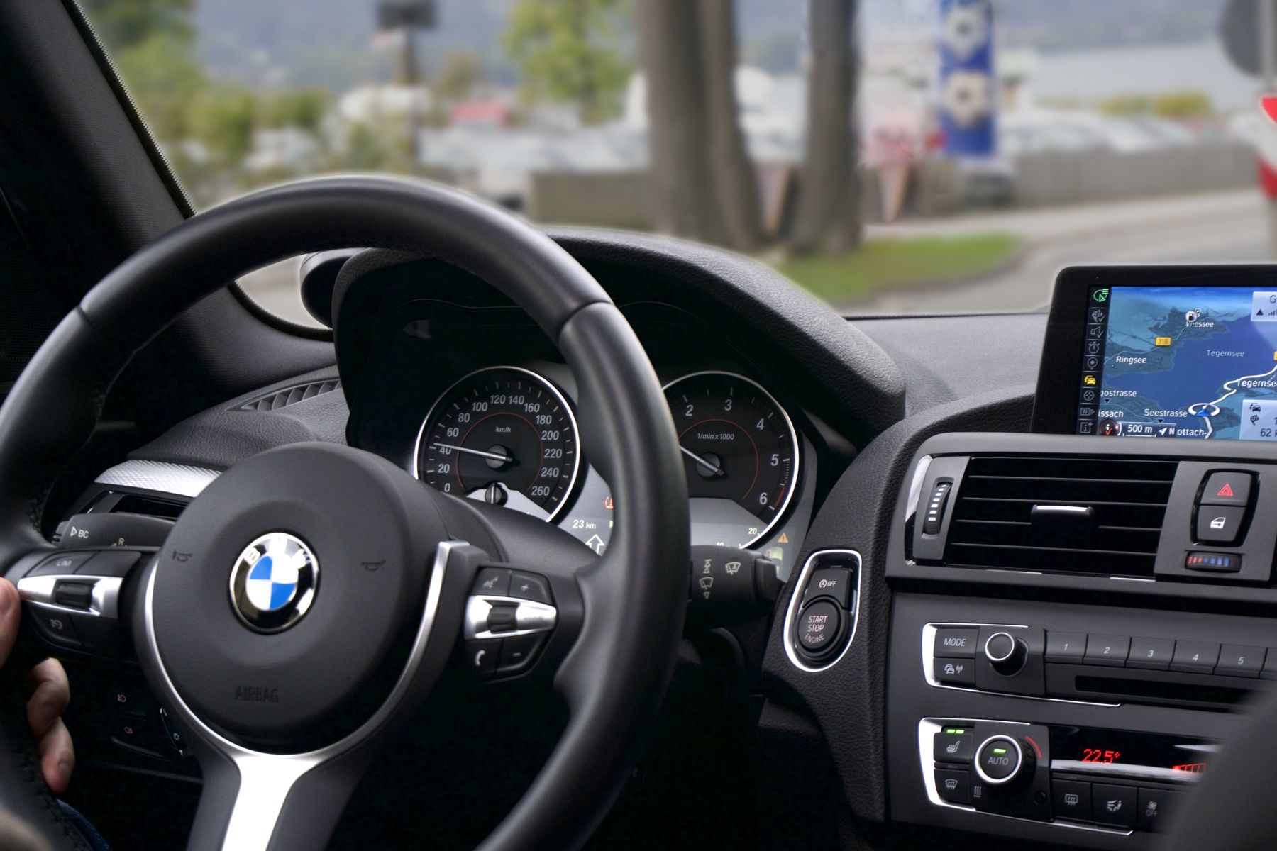 Driver's view of a precision cockpit — steering wheel, gauges, and the road ahead