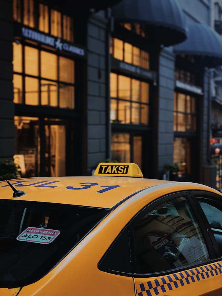 A Yellow Taxi Parked On The Street