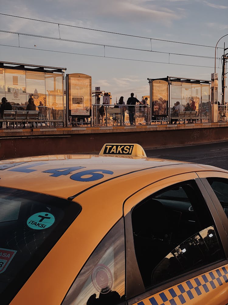 A Yellow Taxi Parked On The Road