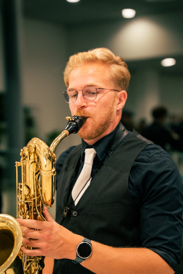 A Man Playing The Baritone Saxophone 