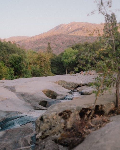 Rock Formationand Stream with Mountains in the Distance 