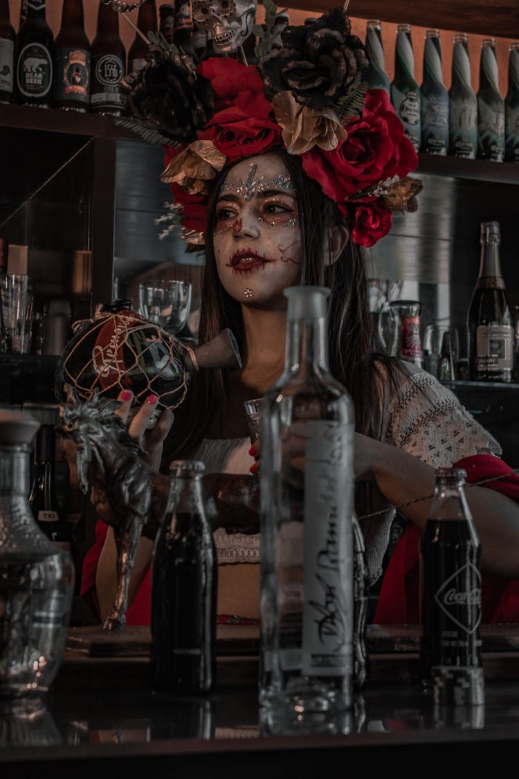 A Woman With Face Paint In A Bar