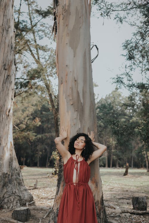 Free Photo of a Woman Posing in front of a Tree Stock Photo