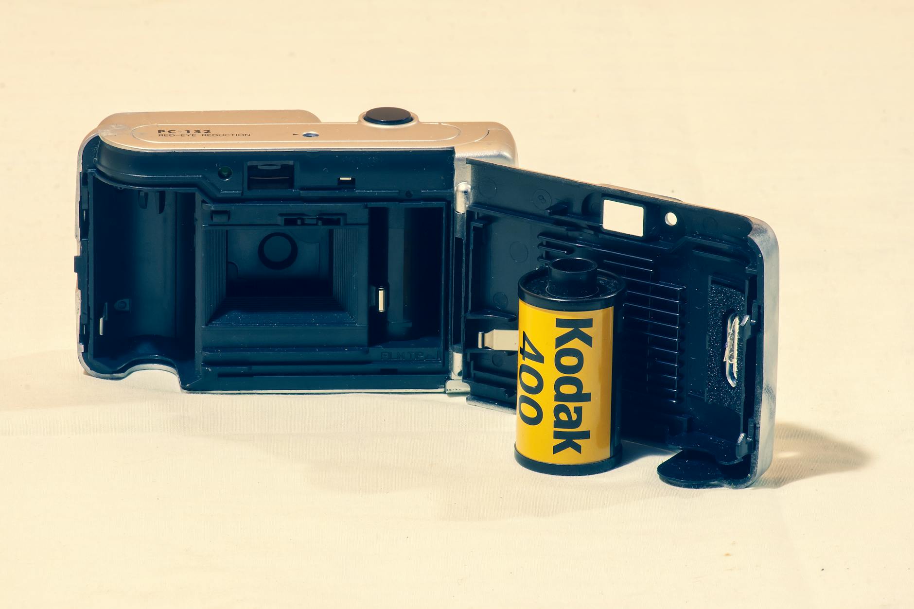 Open vintage camera showing Kodak 400 film roll, perfect for retro and analog photography themes.