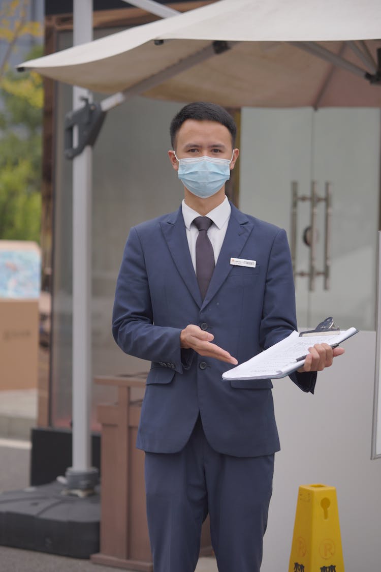 Man In Face Mask With Survey