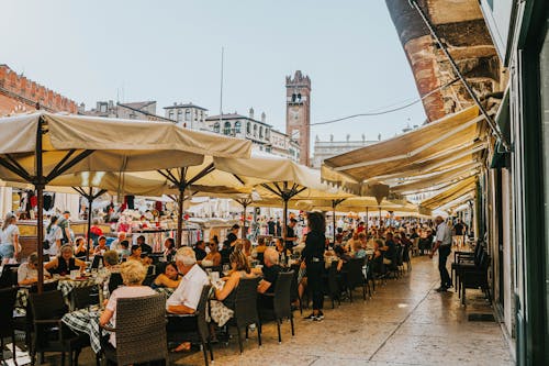 Crowded Sidewalk Cafes in a Town Square 