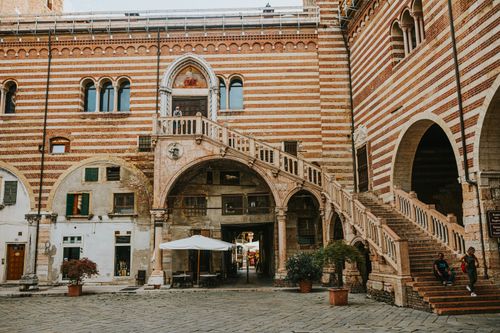 Free Beautiful historic courtyard and staircase in Verona, showcasing traditional Italian architecture. Stock Photo
