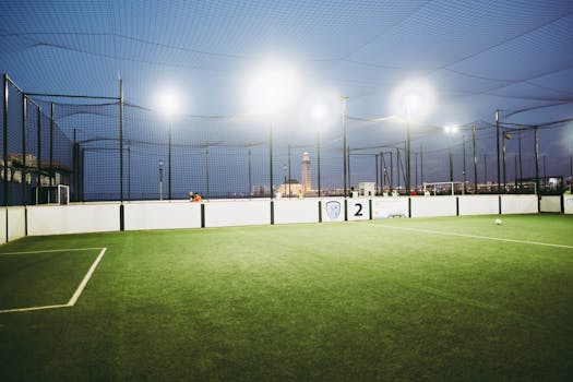 Illuminated soccer field with Hassan II Mosque in the background, Casablanca.
