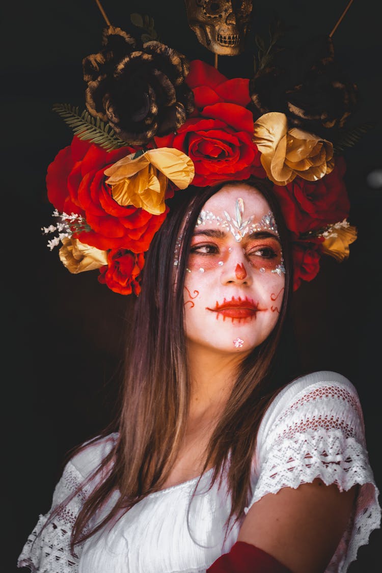 Woman With Painted Face And Flowers On Head