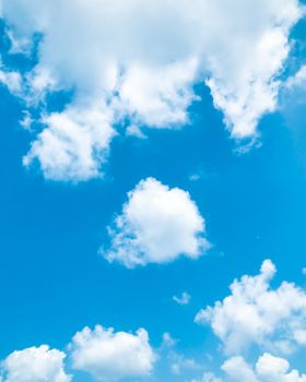 A clear blue sky filled with fluffy white clouds, perfect for backgrounds and nature themes.