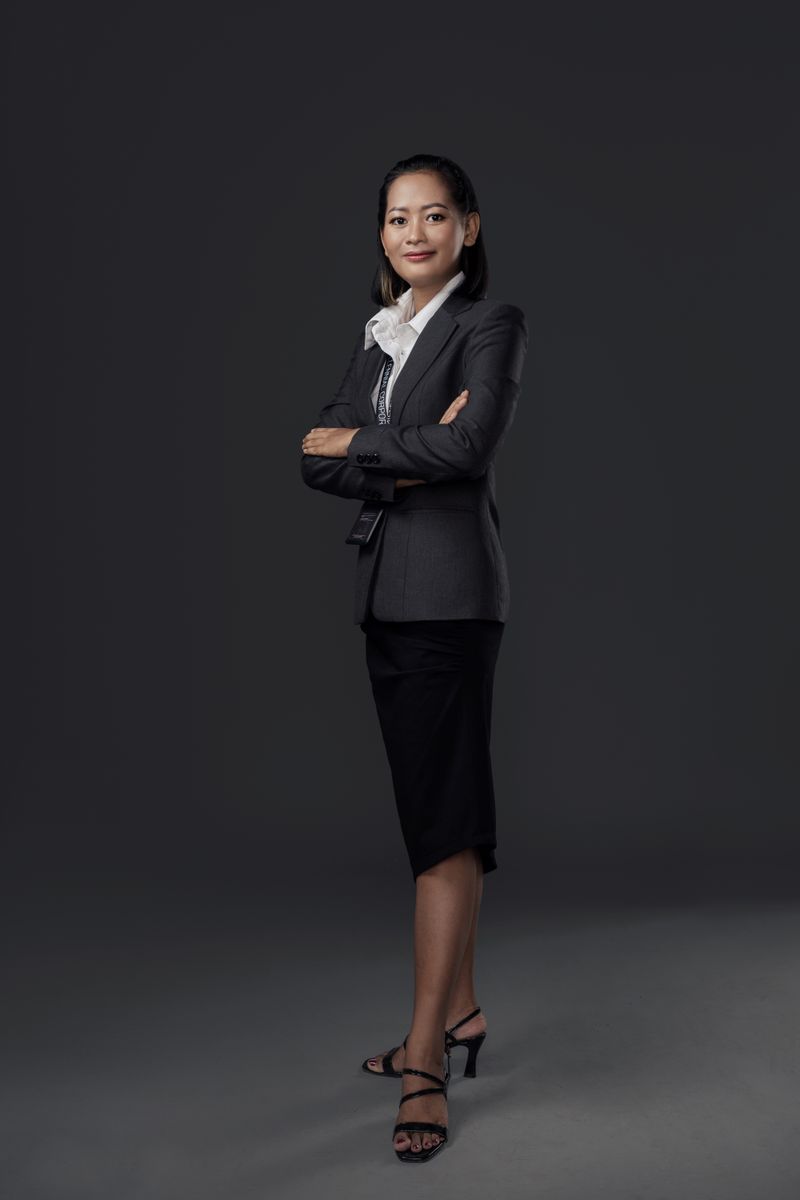 Portrait of the studio principal against a warm neutral background