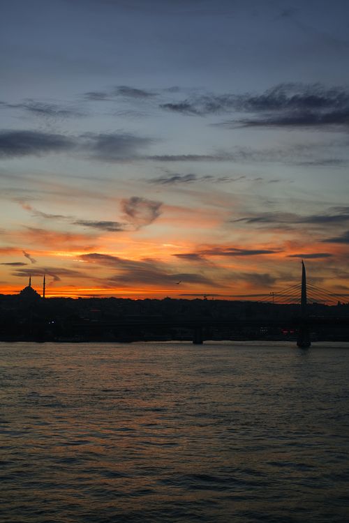 Free Dramatic sunset over the Bosphorus in Istanbul, capturing silhouettes and vibrant sky. Stock Photo