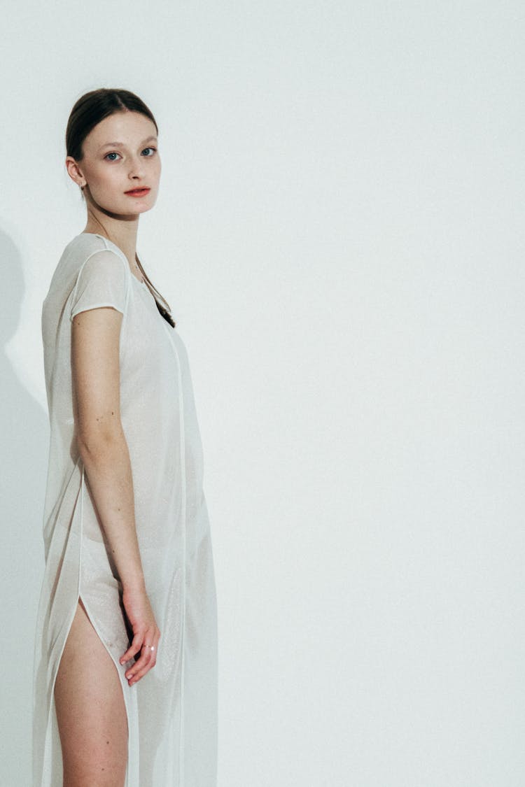 Standing Young Woman In Long White Dress