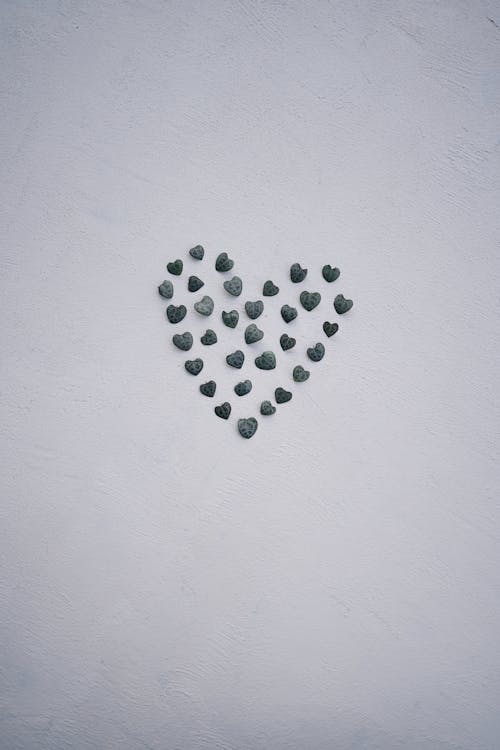 Heart Made of Small Pebbles on White Back