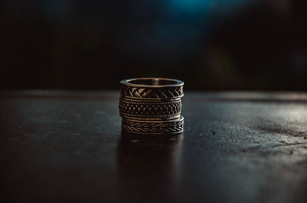 close up shot of intricately designed vintage metal rings stacked toge