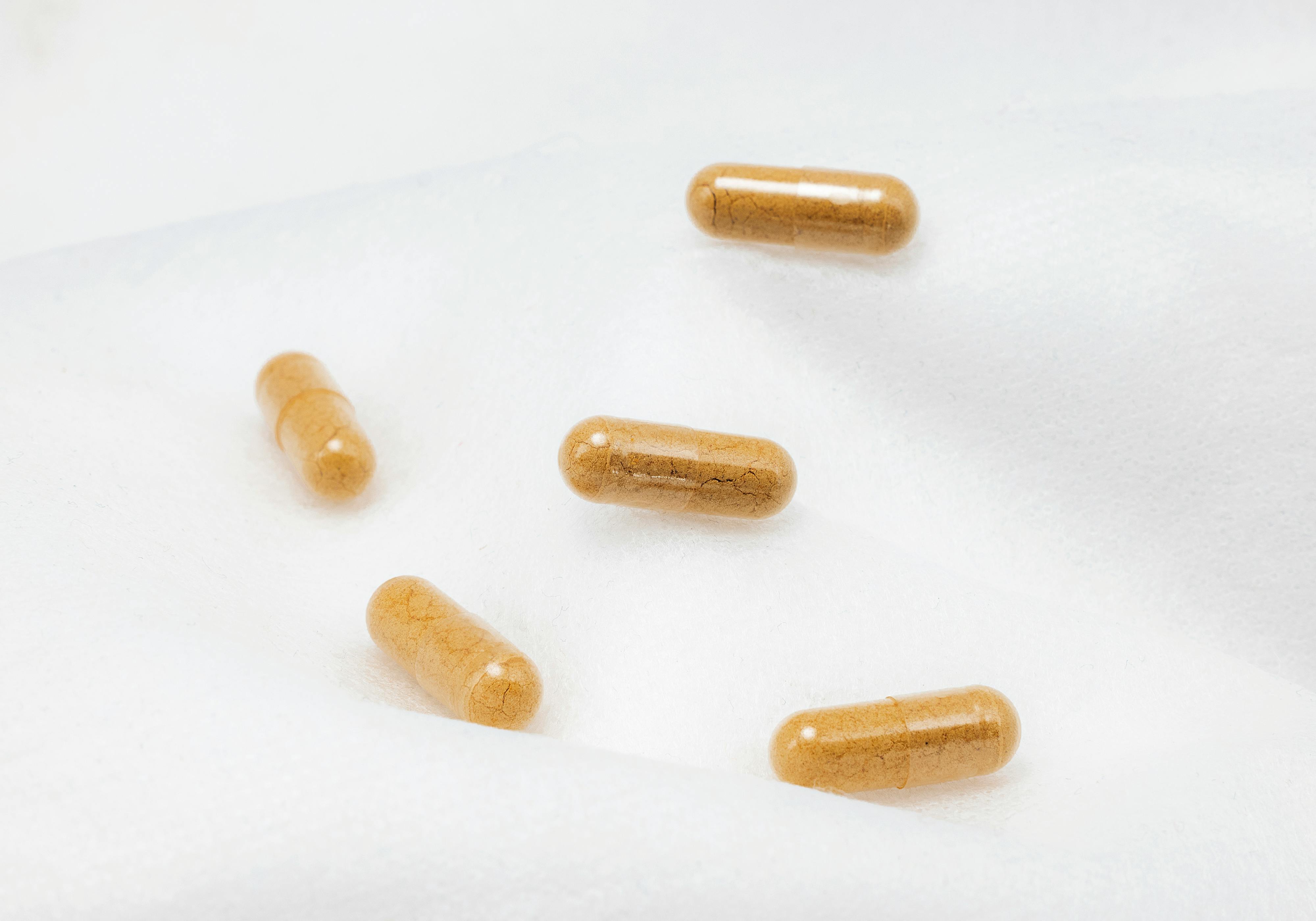 capsule supplements on white surface