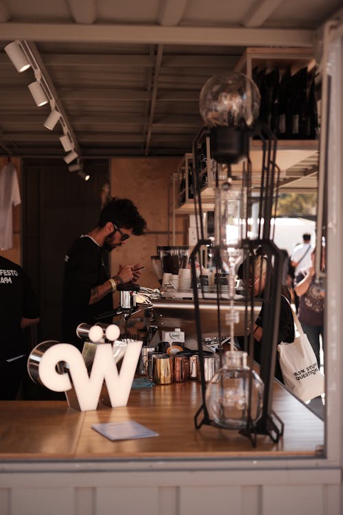 Man Standing behind a Counter in a Cafe 