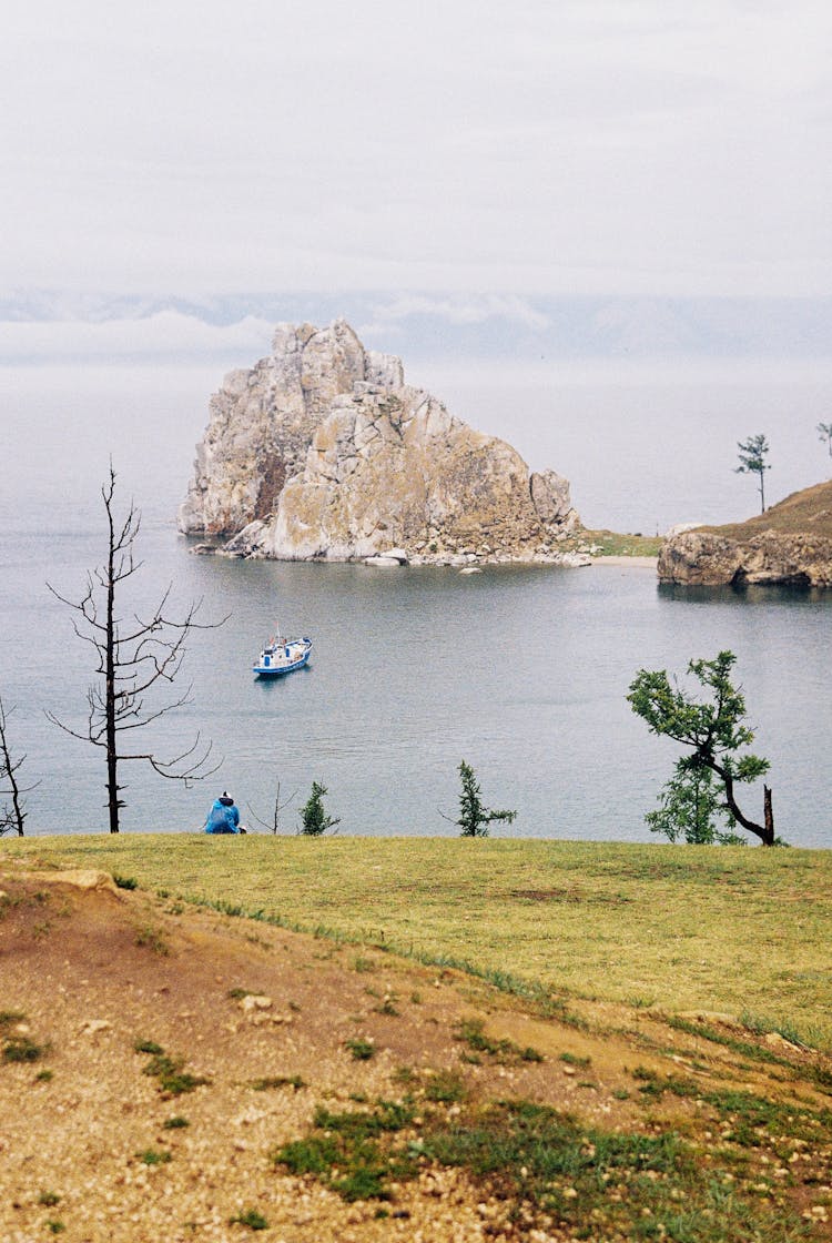 Boat On Sea Near Rock Formation