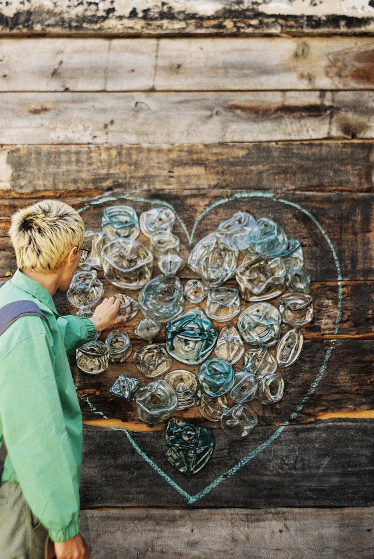 Man Touching An Art Installation In Form Of Heart