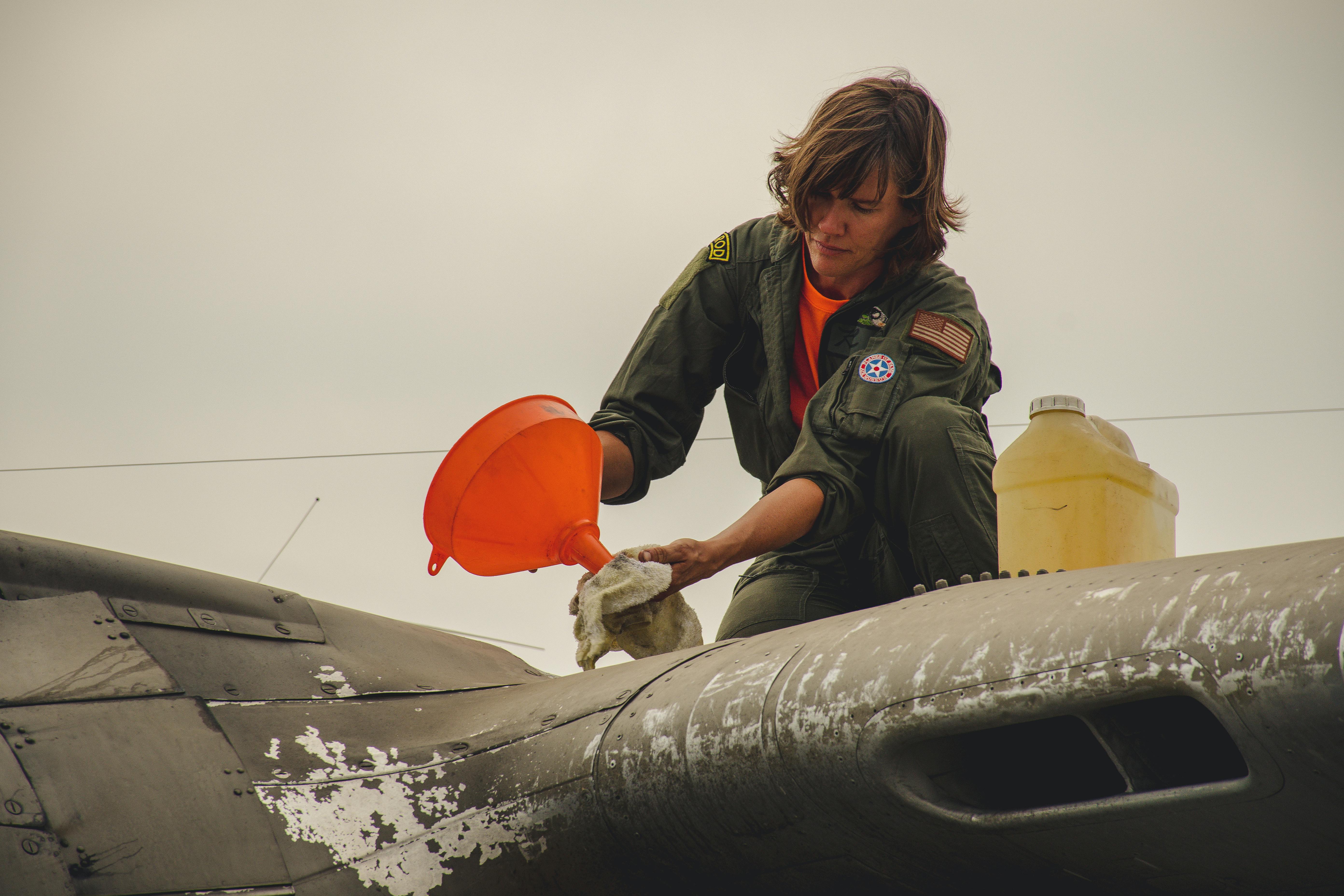 person cleaning aircraft