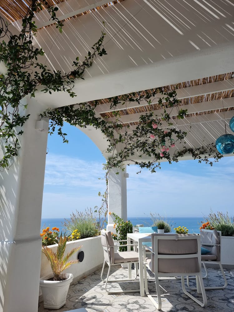 Chairs And Table On Porch With Ocean View