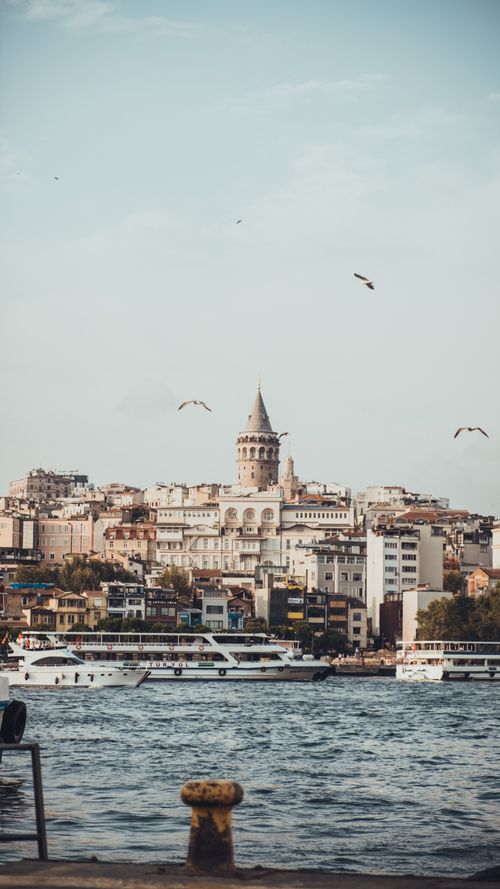 Free Scenic view of Galata Tower and waterfront boats in Istanbul, Turkey. Stock Photo