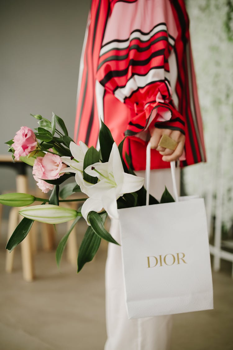 Woman Holding A Paper Bag With A Flowers