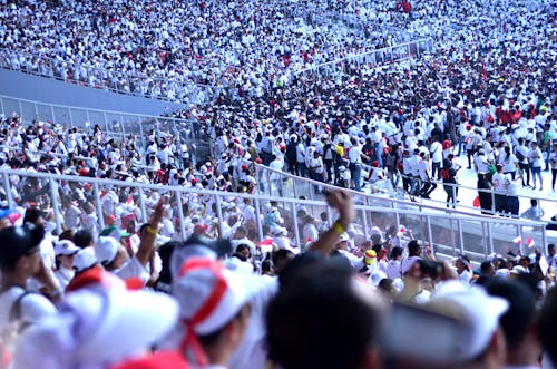 Crowd of a thousands of people in white uniform
