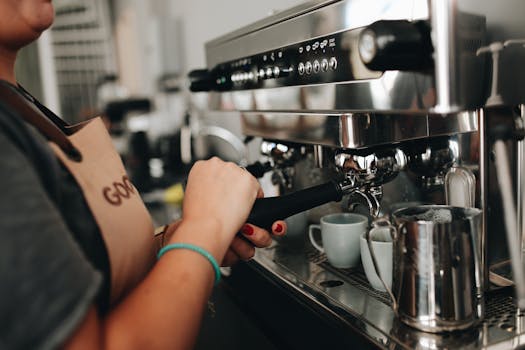 Close-up of a barista using an espresso machine in a cozy café setting.