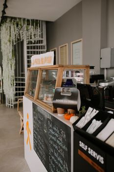 Modern café counter with menu and decor elements creating an inviting atmosphere.
