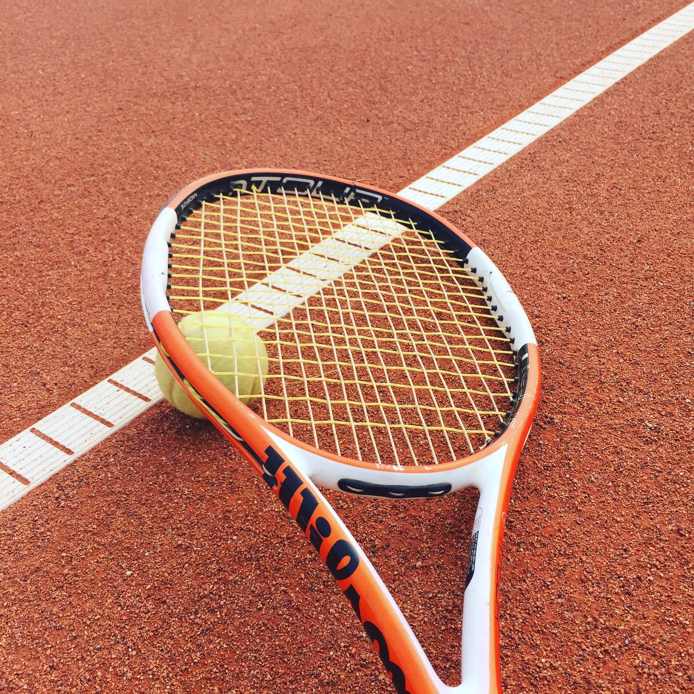 Rackets and tennis balls on the court surface
