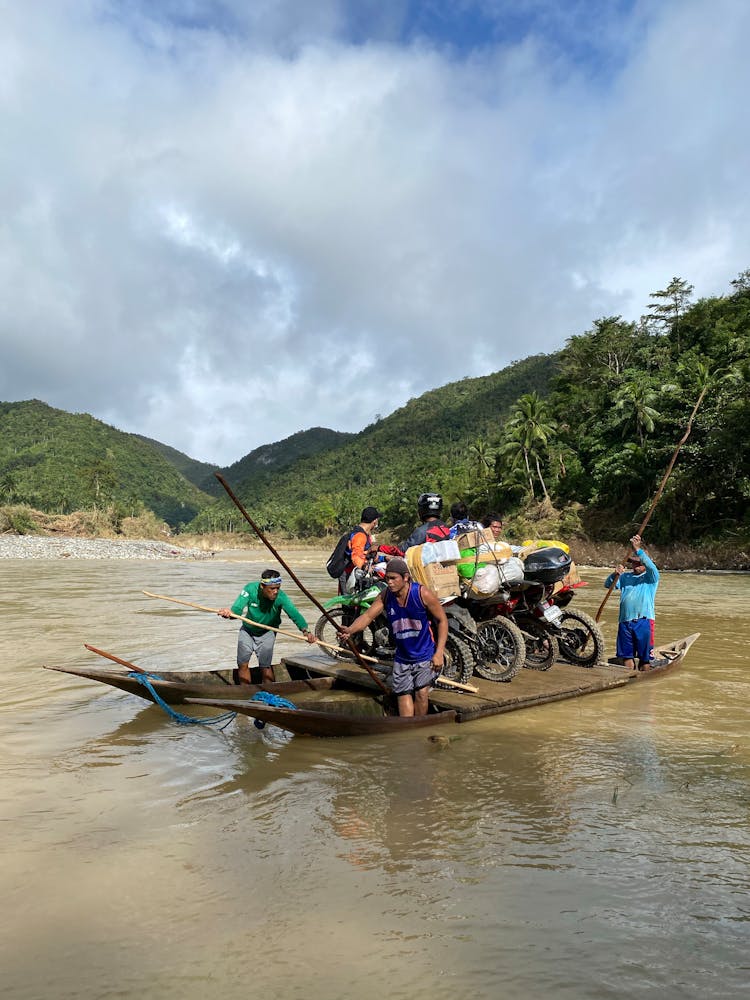 Men In Boat In River In Nature