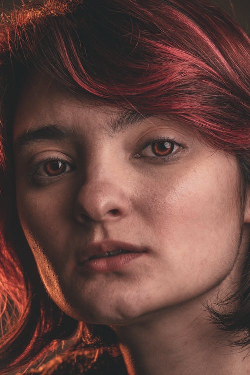 A Woman with Red Hair Looking at the Camera