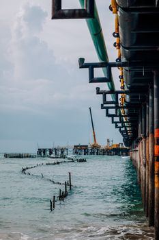 Seaside industrial scene with a crane and pier in Paracuru, Brazil. Captivating coastal view.