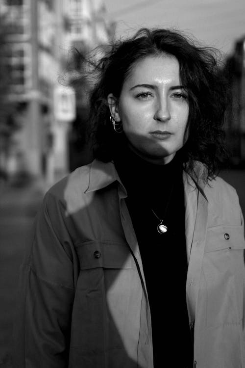 Grayscale Photo of a Woman wearing a Jacket 