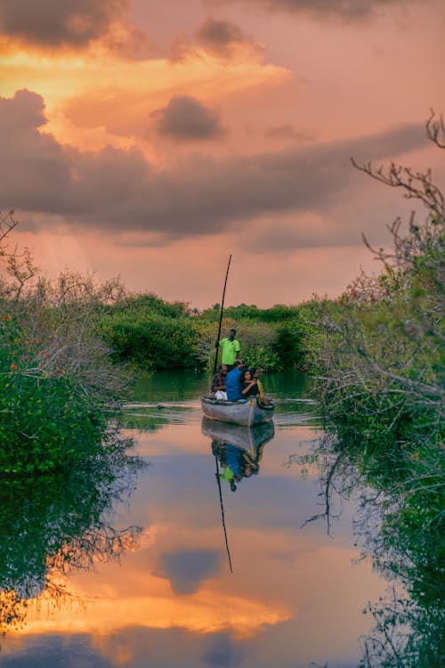 Wooden boating on backwater sunset background