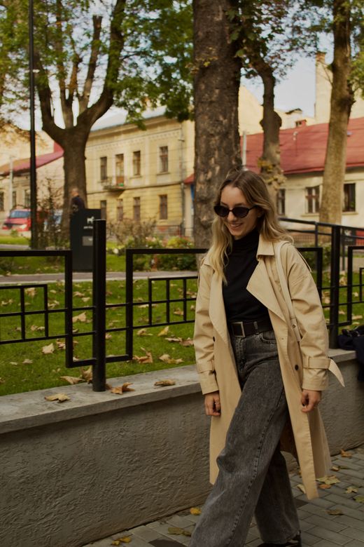 Model in a deep green belted coat — photo by Katia Damyan on Pexels