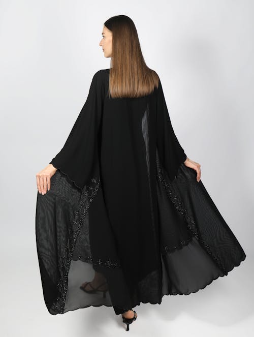 Back View of a Woman Wearing a Black Gown