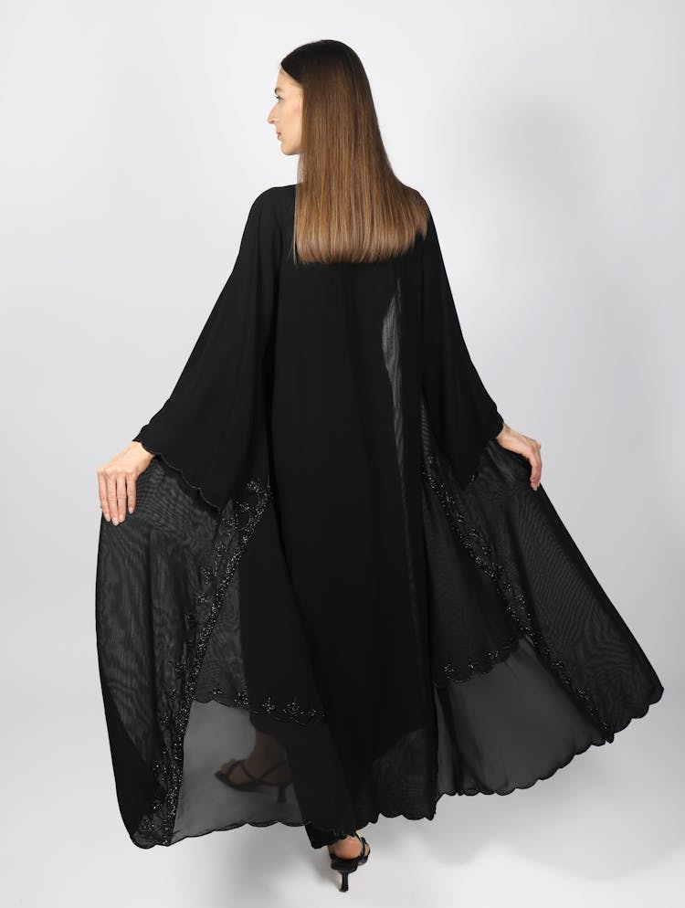 Back View Of A Woman Wearing A Black Gown