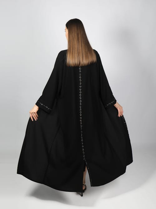 Back View of a Woman Wearing a Black Gown