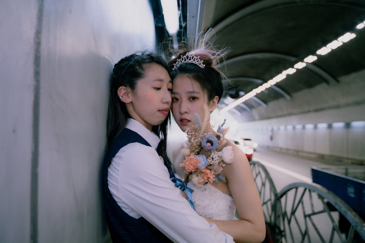 Women Hugging In Tunnel