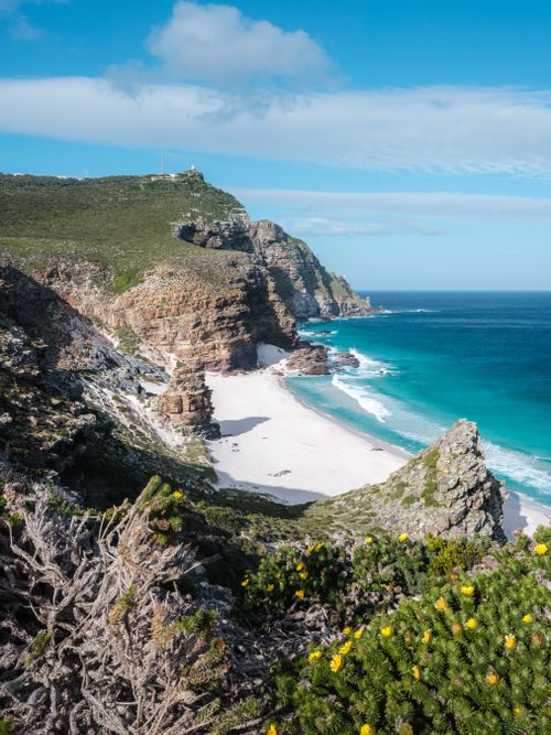 Free Explore the stunning rocky cliffs and turquoise waters of Cape Peninsula under a clear blue sky. Stock Photo