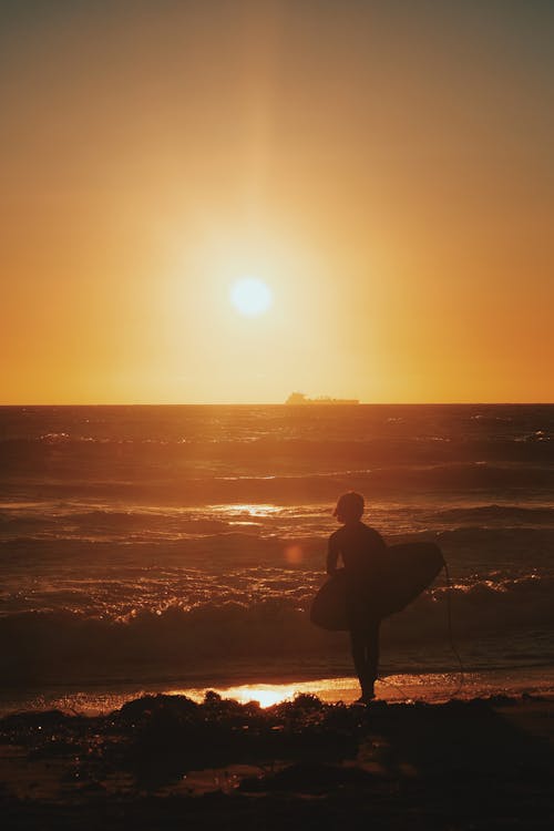 Silhouette of a Surfer on the Beach