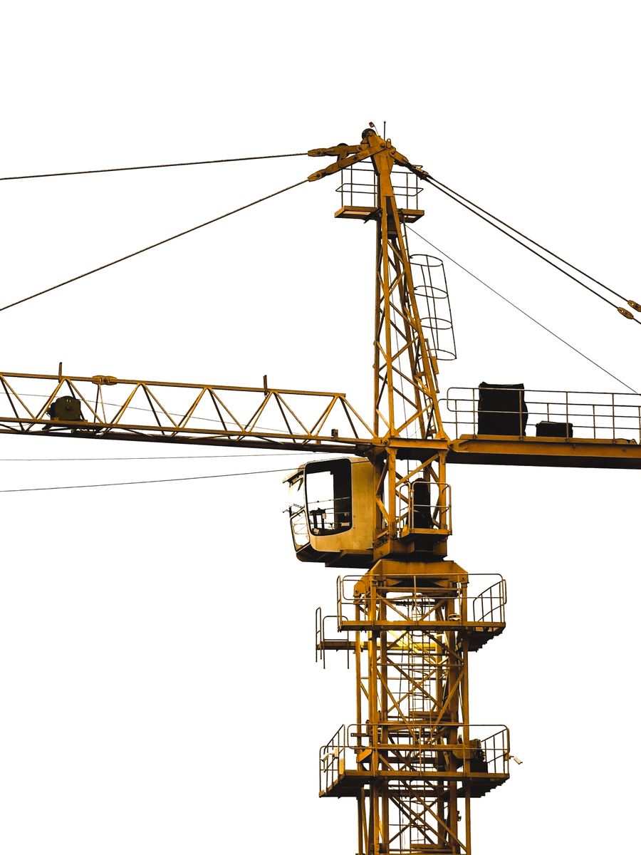 Yellow tower crane at a construction site