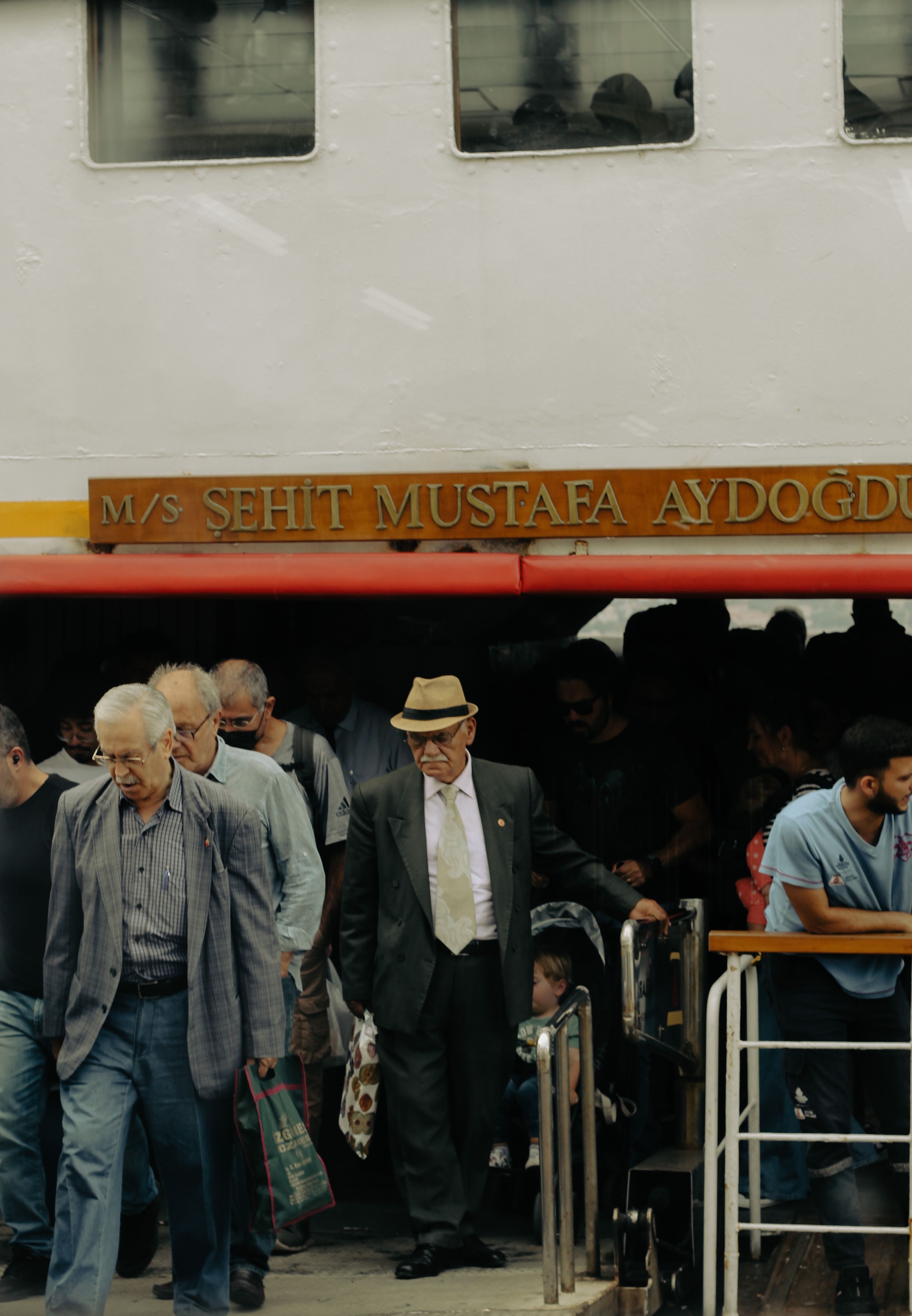 A bustling scene of passengers disembarking a ferry in Istanbul, Turkey. Urban daily life.