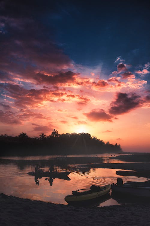 Boats Docked on Shore during Sunrise