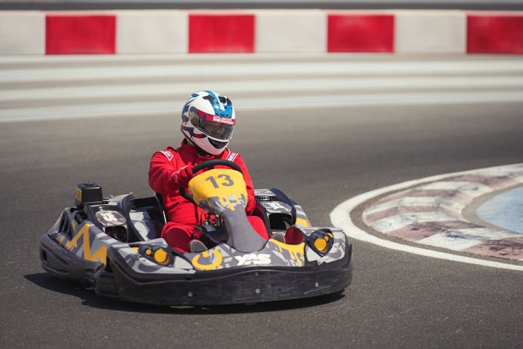 A Man Riding A Go Kart On The Race Track