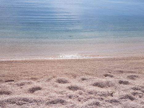 Tranquil view of sandy beach and calm sea waters in Split, Croatia.